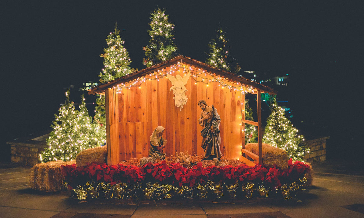Wooden Nativity set in front of a home