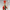 Toy soldier with red hat and green body on a gray background