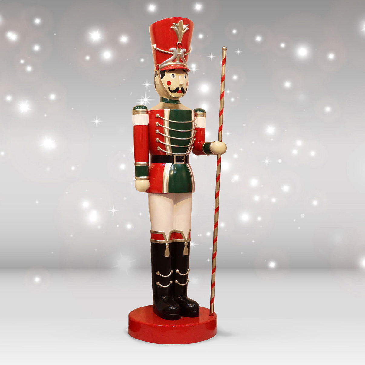 Decorative toy soldier figure with a red hat and striped cane on a sparkling background