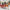 Family with children in a Santa sleigh at a shopping mall decorated for Christmas.