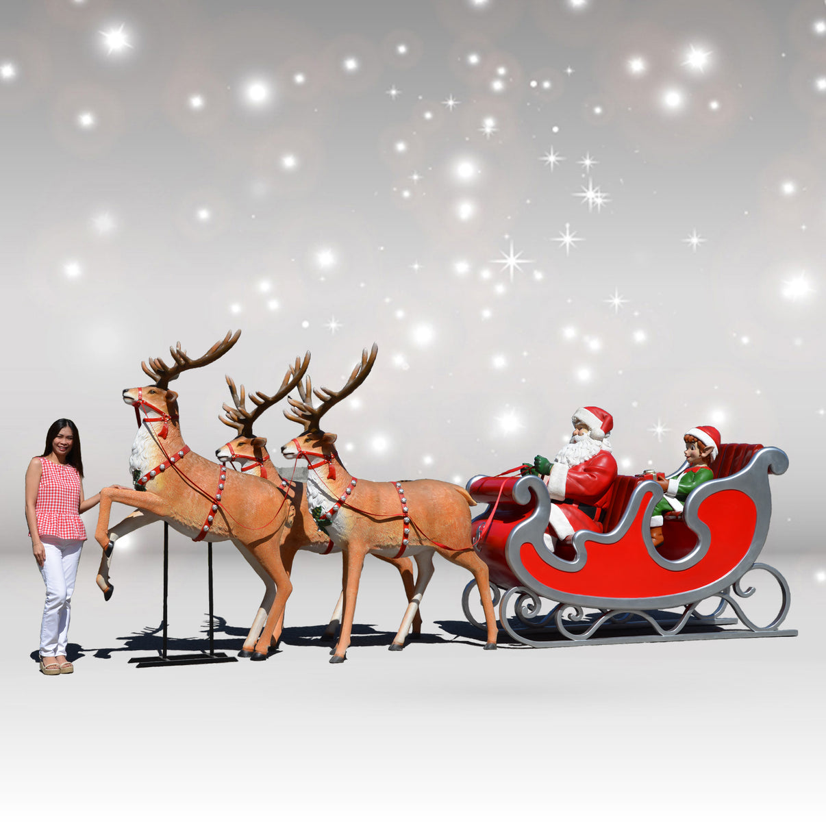 Model of Santa Claus in a sleigh with reindeer against a starry sky background