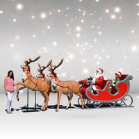 Model of Santa Claus in a sleigh with reindeer against a starry sky background