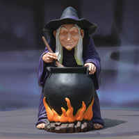 Witch figurine with a cauldron on a dark background